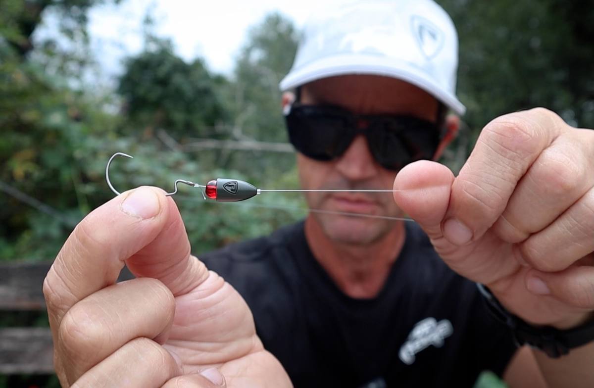 Close-up of an offset hook and bullet-shaped weight rigged on light line